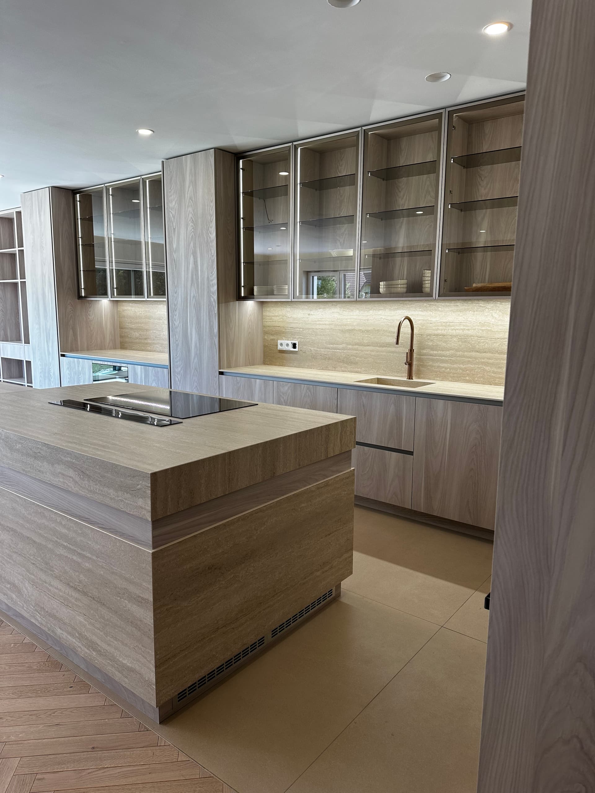 Travertine kitchen island with integrated induction cooktop